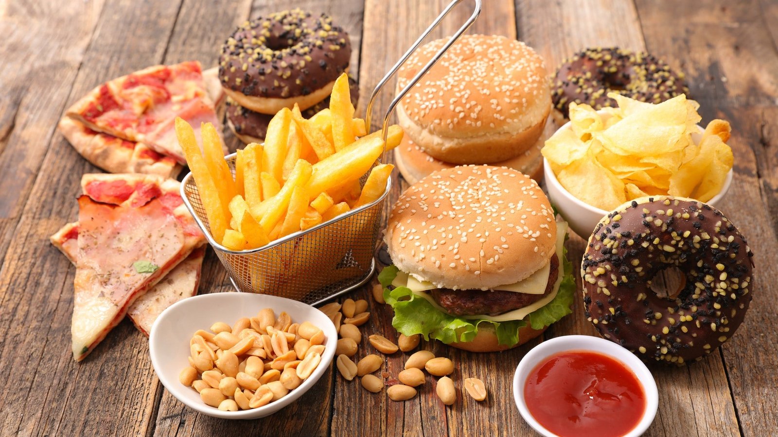 Array of everyday foods linked to cancer risk, including processed meats, sugary drinks, and microwave popcorn. Highlighting the importance of healthy choices.