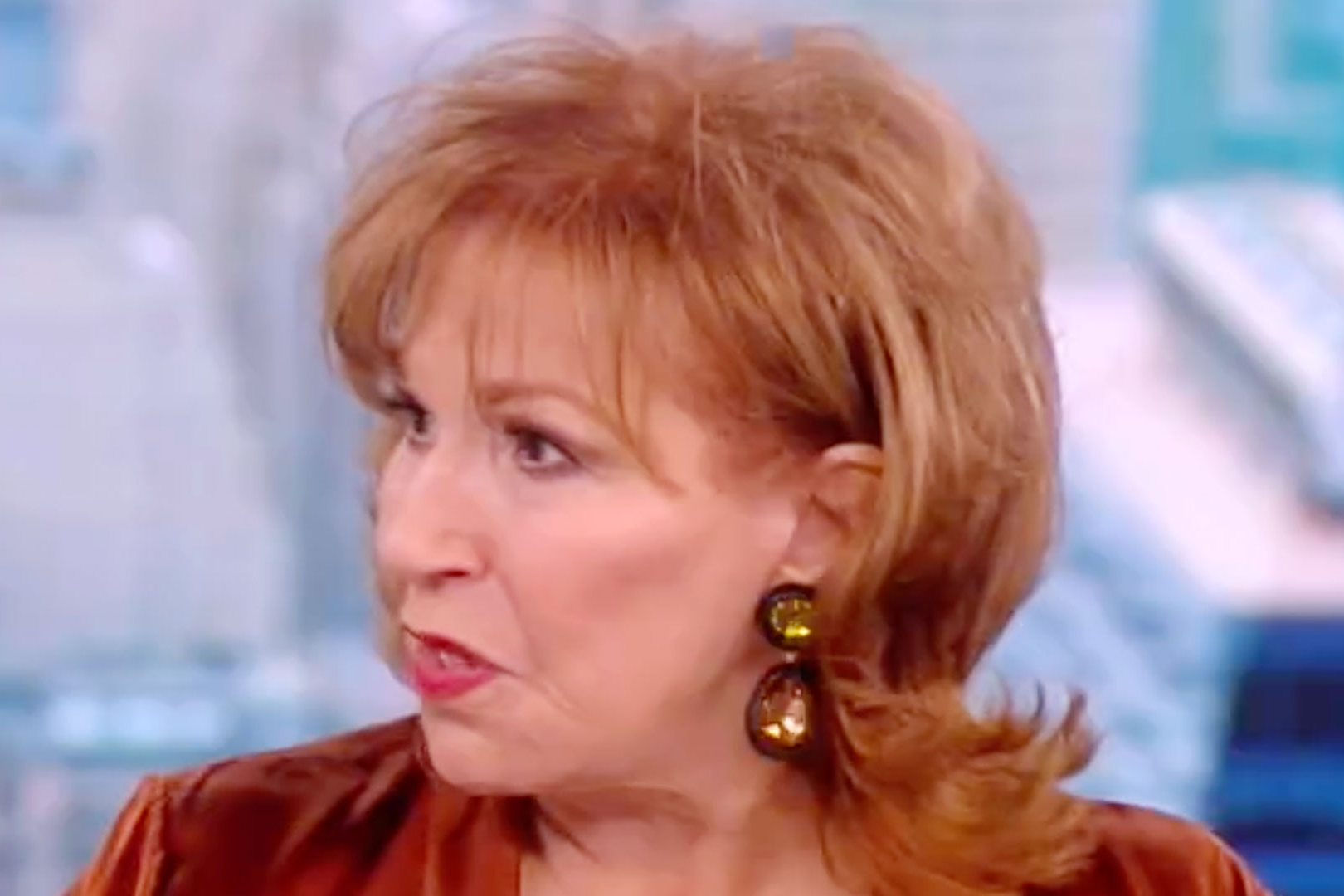 Joy Behar reacting intensely as a guest challenges her during a heated exchange on live TV